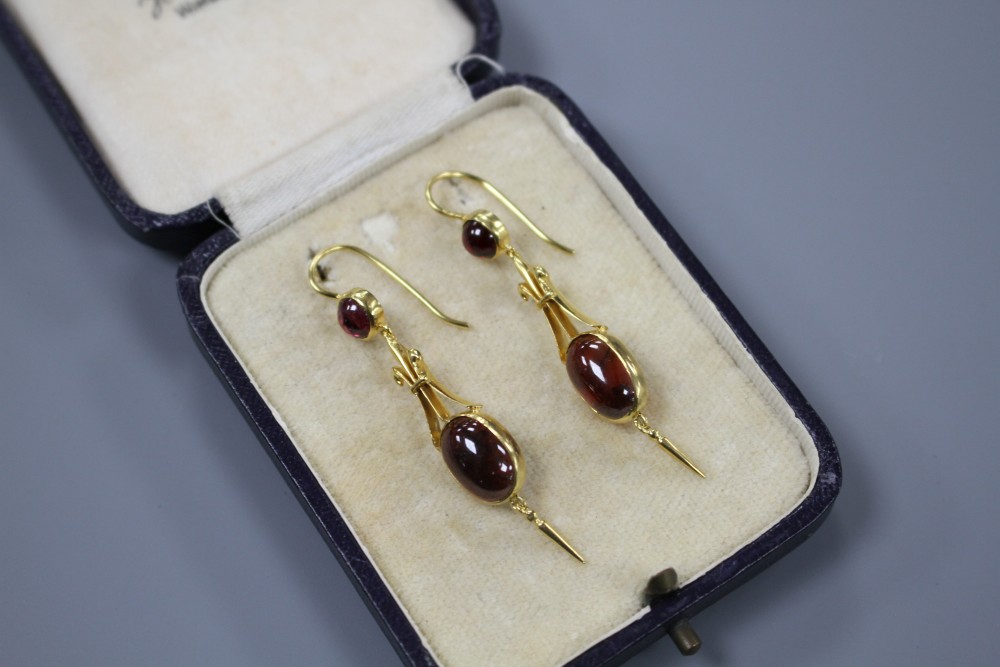 A pair of Victorian style yellow metal and cabochon garnet set drop earrings, overall 50mm, gross weight 5.1 grams.